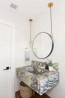Calacatta Viola Marble Rectangular Wall-mount Bathroom Sink with 8" Backsplash (W)21" (L)34" (H)10" installed bathroom round mirror white door a plant and a bamboo bucket wide view
