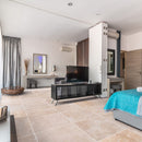 classic light beige travertine tile 24x24 Honed and Filled installed to a hotel room floor closeup