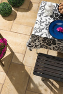 manufactured stone pavers Sienna Dark Yellow Antique Pattern F01DY 317917 installed outdoor patio bench angle view