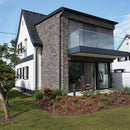 manufactured stone veneer slate look Sierra anthracite handmade S05TH 101220 installed facade of modern house glass balcony