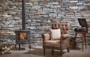 manufactured stone veneer slate look Sierra ash handmade S05AS 101219 installed inside house black stove armchair vintage stand alone record player