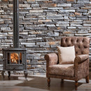 manufactured stone veneer slate look Sierra ash handmade S05AS 101219 installed inside house black stove armchair