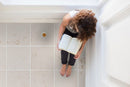 mayra white limestone 24x24 woman sitting reading book