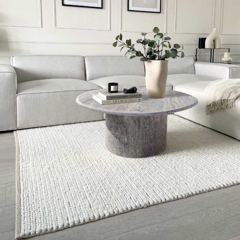 Silver Travertine Vein-cut Round Honed 2" Tabletop Coffee Table (D)36" (H)16" white area rug and gray couch