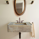 Walnut Travertine Rectangular Wall-mount Bathroom Sink Fluted (W)16" (L)32" (H)10" bathroom bronze color drain pipe and faucet along with sconces and mirror